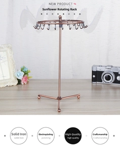 Close-up of rotating bronze iron jewelry stand with sunflower hooks and stable tripod base
