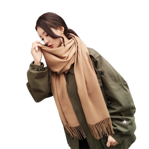 Women's warm camel cashmere-like scarf with tassels styled for winter wear