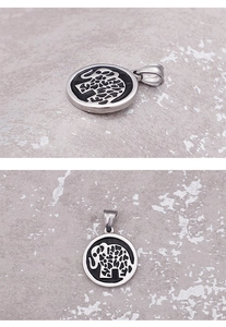 Detail shots of round silver elephant pendant showing hollow pattern on stone background