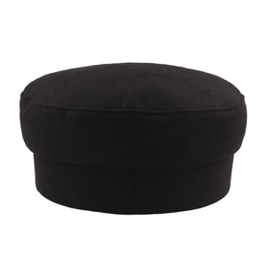 Women's black wool baker boy hat with leather brim shown in a side view profile