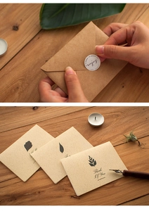 Detail of vintage kraft paper greeting cards with leaf patterns and sealing stickers