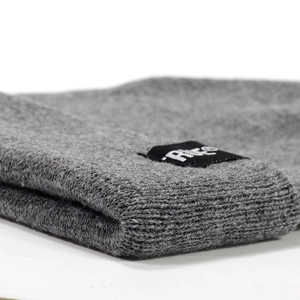 Winter grey knit beanie with True woven label showing warm fabric and high-quality texture