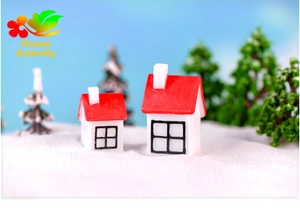 Miniature snow scene decor featuring tiny red-roofed houses and pine trees for crafts