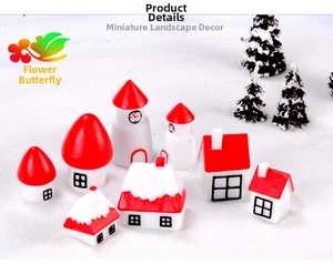 Miniature Christmas house village with red roofs and snowy pine trees landscape