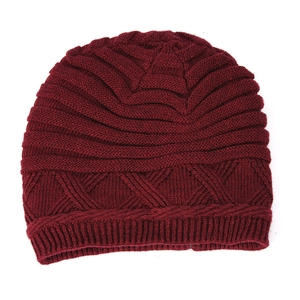 Detailed knit pattern on wine red winter beanie featuring ribbed cuffs and thick texture