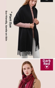 Close-up detail of soft black and dark red cashmere scarves with fringed tassel edges