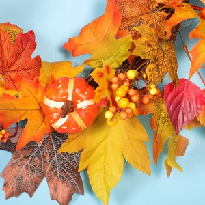 Autumn maple leaf wreath with mini pumpkin and berries for Thanksgiving home decoration