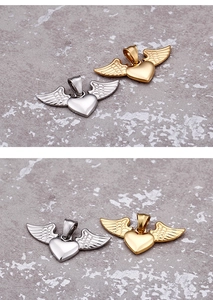Detailed view of heart-shaped angel wing pendants in polished gold and silver finishes