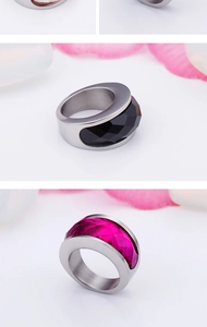 Detail of stainless steel wide band ring with black and rose red faceted crystals