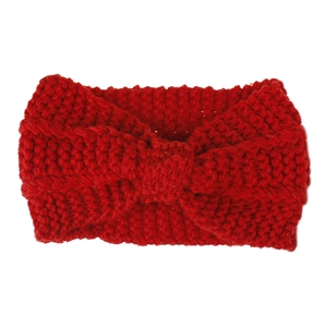 Detail of red chunky knit headband featuring classic bohemian twist knot design for winter