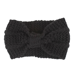Detail of black chunky knit ear warmer headband with a classic bow design for women
