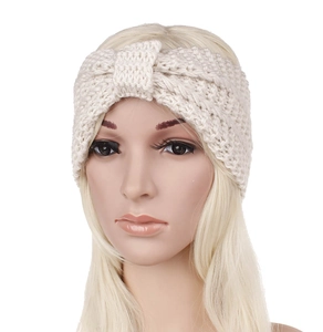 Detail of a beige thick knit winter headband with a bohemian knotted twist design