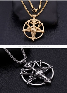 Macro detail of gold and silver Pan deity goat head pendants on twisted chains
