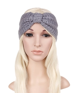 Detail of grey cable knit headband with a decorative bow knot on a model head