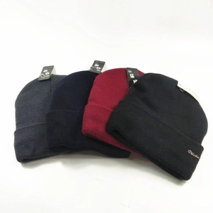 Set of winter knit beanies in gray, navy, red, and black with warm acrylic yarn fabric