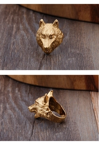 Detailed views of gold wolf head ring showcasing embossed texture and vintage style