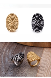 Detailed view of oval spiral textured rings in golden and silver stainless steel
