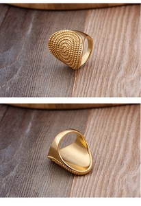 Detailed view of golden spiral woven texture on a punk style stainless steel ring
