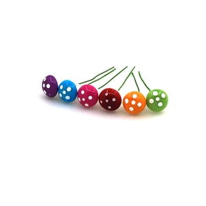 Close-up of colorful foam mushroom ornaments with metal wire stems for Christmas trees