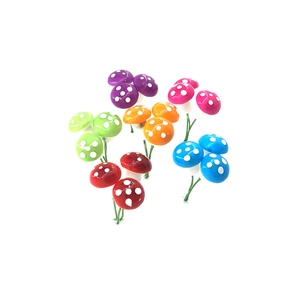 Detailed view of colorful miniature mushrooms with wire stems for Christmas decoration