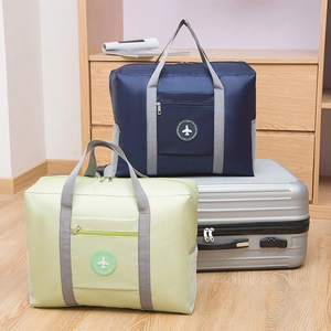 Thickened foldable travel bag in navy and green shown on luggage with large capacity