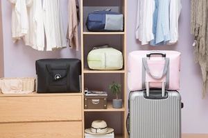 Foldable travel bag detail showing trolley sleeve attachment for suitcase luggage