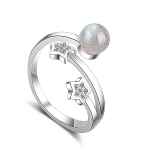 Minimalist silver star ring with round moonstone and sparkling rhinestones on white background