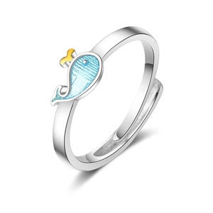 Adjustable silver ring with a cute blue whale and golden crown on white background