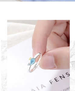 Macro shot of a cute 925 silver whale ring with blue enamel and yellow tail accents