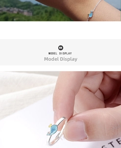 Detail view of adjustable silver whale ring and matching bracelet with blue oil drip finish