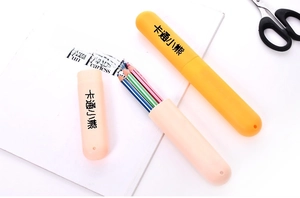 Portable colorful toothbrush cups in yellow and pink on a white surface with magazine