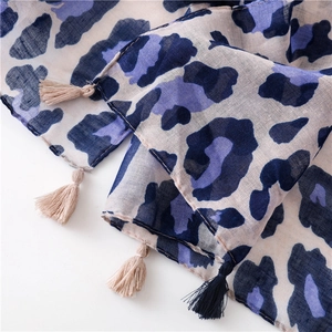 Close-up of leopard print scarf with fringe tassels in purple and blue tones