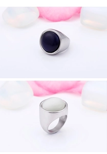 Detail of titanium steel ring with opal stones in deep purple and creamy white tones
