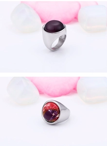 Detail of silver steel rings featuring deep purple opal and red textured stone inlays
