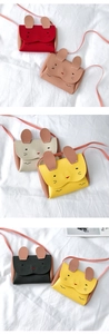 Detailed view of color-blocked bunny ears kids crossbody bags in textured leather