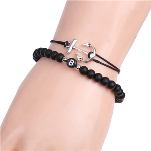 Detail of black matte bead letter B bracelet and silver anchor pendant rope jewelry set