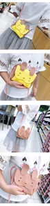Detail of yellow and pink rabbit shoulder bags for kids with cute ear designs