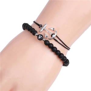 Detail of 6mm matte bead bracelet with letter V and woven rope anchor charm on wrist