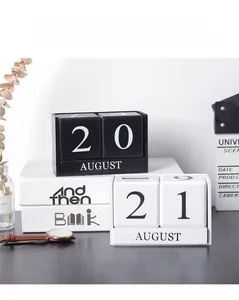 Detail of wooden perpetual calendar blocks with August display in minimalist black and white