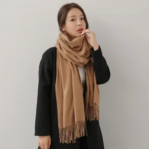 Elegant camel winter scarf for women featuring classic fringes and soft cashmere feel