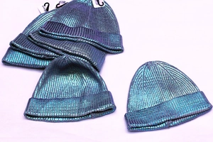 Macro shot of metallic laser blue knitted beanies with reflective ribbed texture details