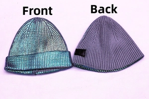 Close-up of dual-sided beanie featuring metallic cyan coating and gray knit interior