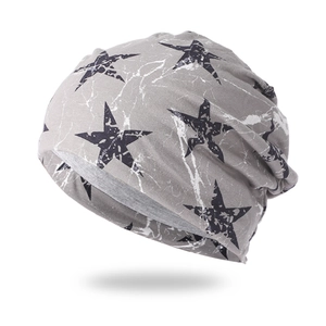 Detail of grey slouchy beanie with black star and white marble crackle pattern