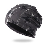 Close-up of black knit beanie with white marble texture and soft thermal lining detail