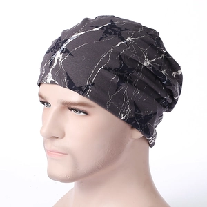 Dark grey slouchy beanie with white marble texture and star pattern on mannequin