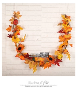 Autumn garland featuring faux sunflowers, pumpkins, and maple leaves on a vine base