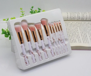 Close-up of 10-piece marble pattern makeup brush set with rose gold ferrules in tray