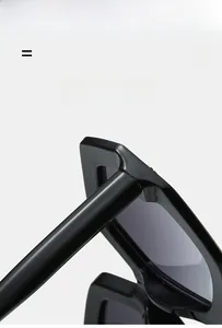 Detailed close-up of flexible hinges and wide temple design on black hexagonal sunglasses
