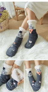 Detail of gray thermal winter socks with cat pattern and thick fleece lining for warmth