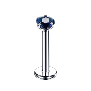 Macro shot of silver stainless steel labret stud with a heart-shaped blue zircon stone